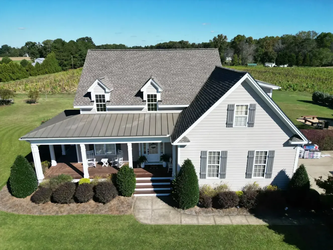 Completed GAF Timberline HDZ Weathered Wood roof replacement on a farmhouse-style home on Scarborowood Dr in Holly Springs, NC